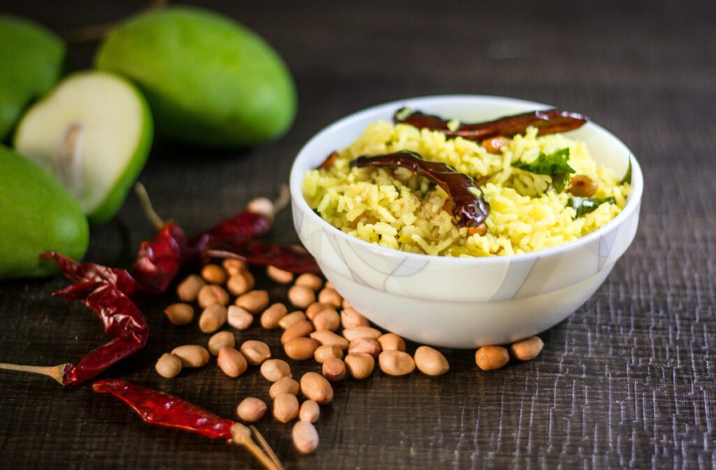 Delicious tamarind rice with peanuts, chili peppers, and mangoes, a traditional Indian dish.